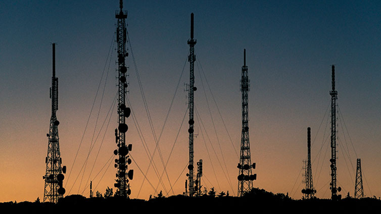 telecommunication poles on the background of sunset